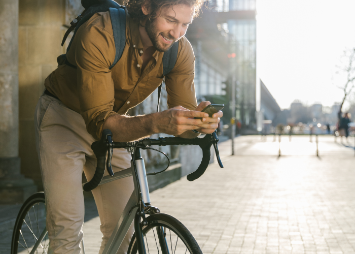 Man using mobile device while on a bike