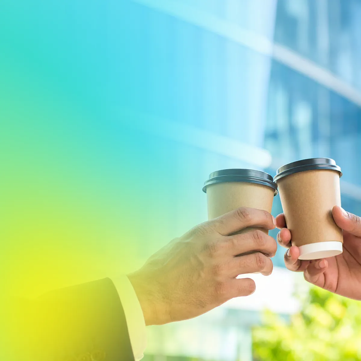 Two people in business attire clink disposable coffee cups together in a toast, with a soft green and blue gradient overlay and an office building in the background.