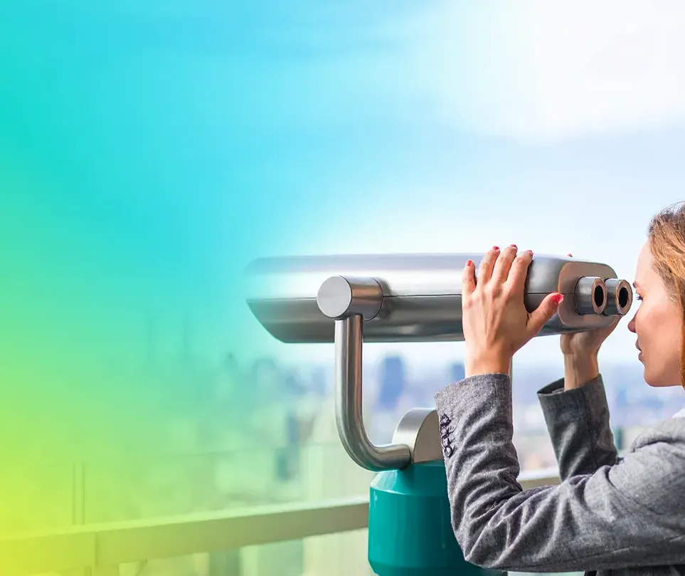 A person in a grey suit looks through a mounted telescope from an observation deck, with a city skyline in the background and a soft gradient of green, blue, and yellow colors overlaying the scene.